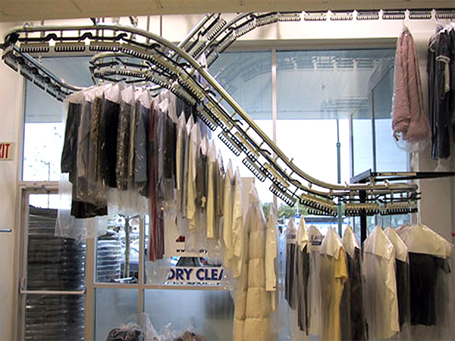 Hangers With Clothes On Garment Conveyor At Dry-cleaner's Stock Photo,  Picture and Royalty Free Image. Image 198000170.